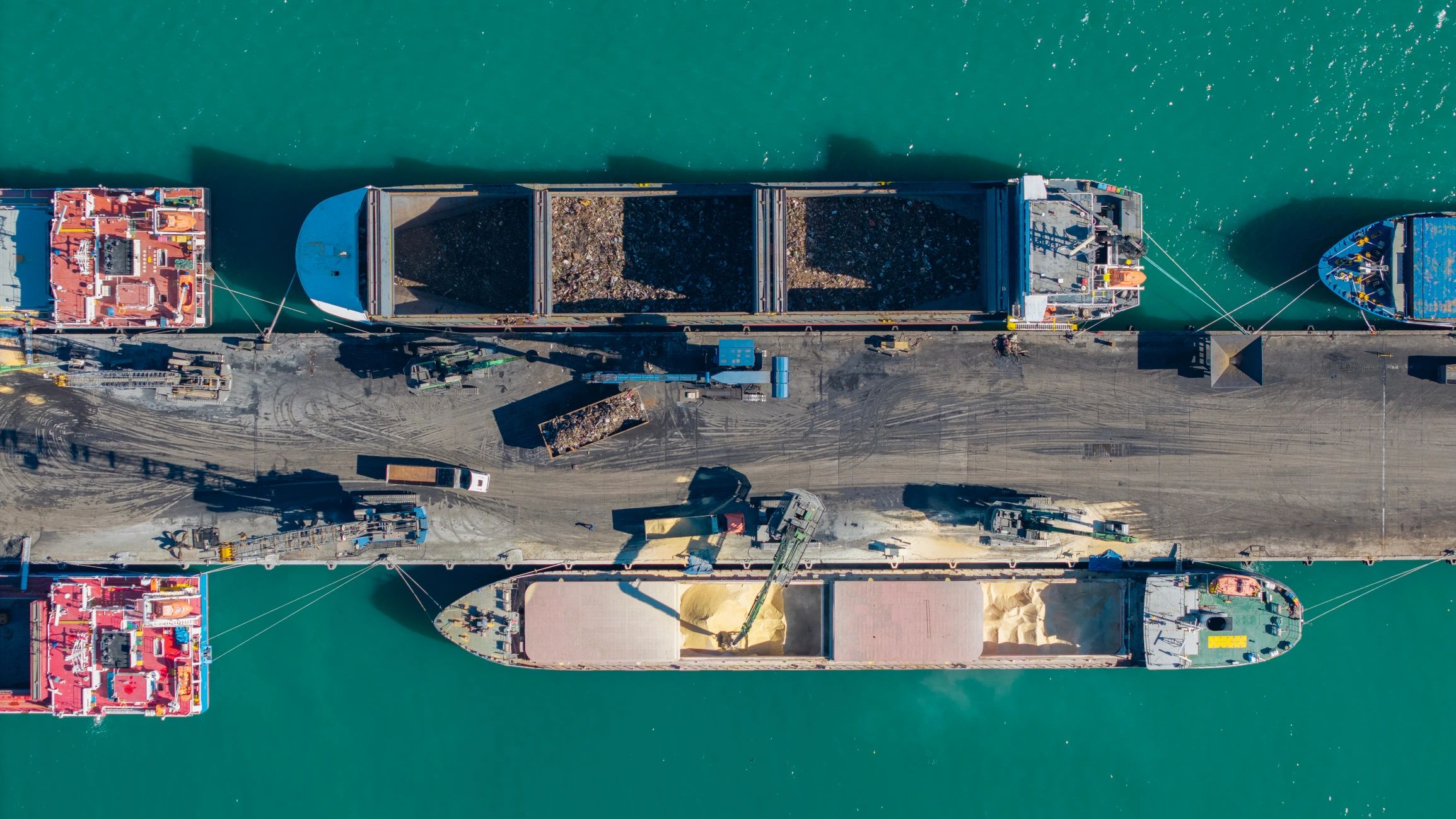 Cargo ships loading agricultural goods at a commercial port