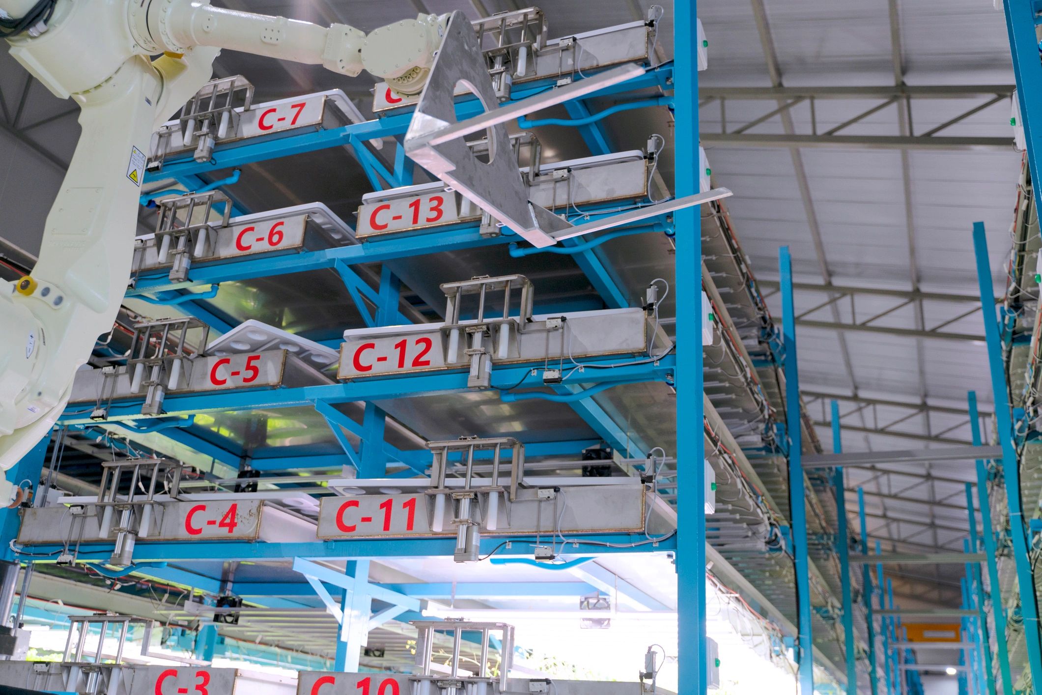 Employee working with robotic arm in hydroponics farm