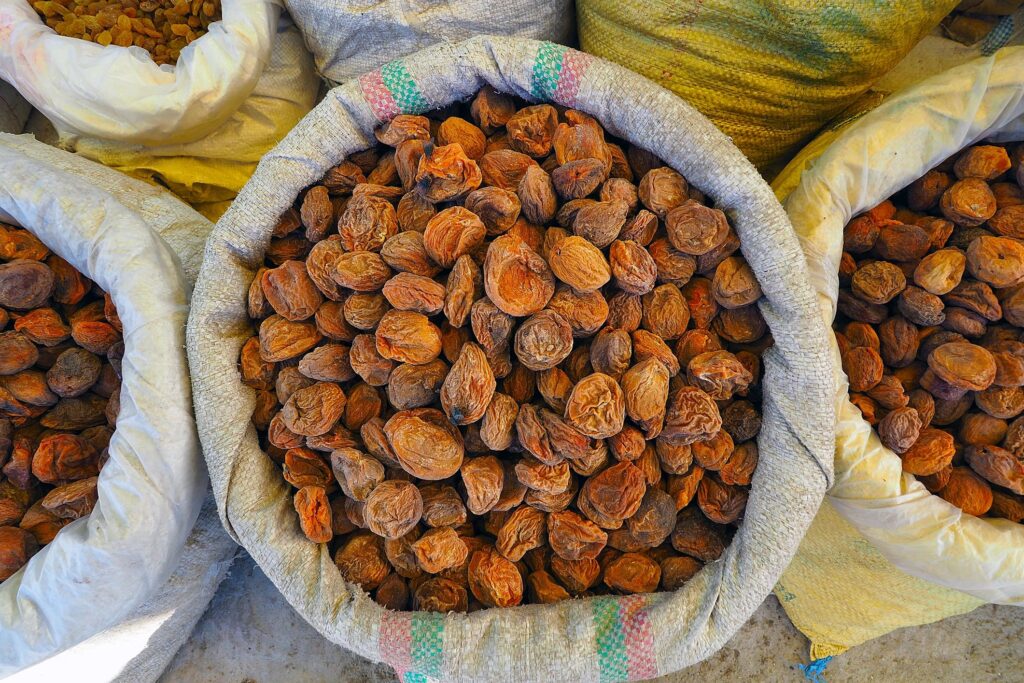 Heap of very dried apricots in bag on street market in Leh Ladakh, India
